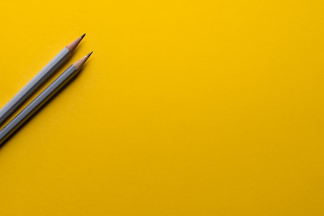 Photo de 2 crayons sur fond jaune